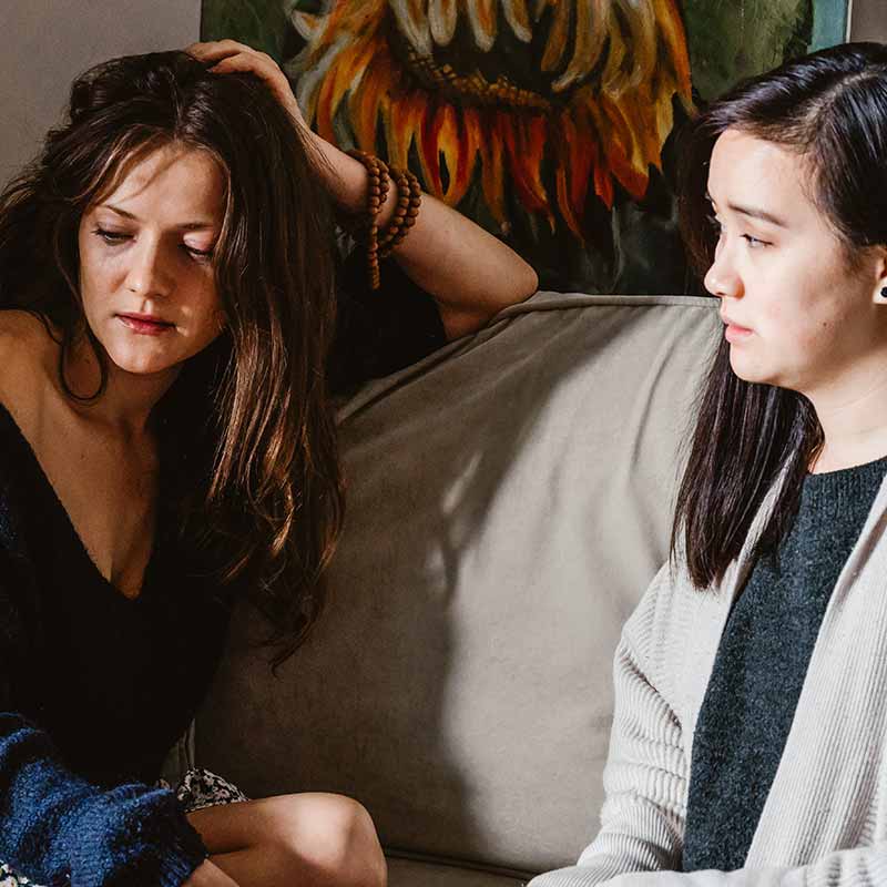 Two women sitting on a couch